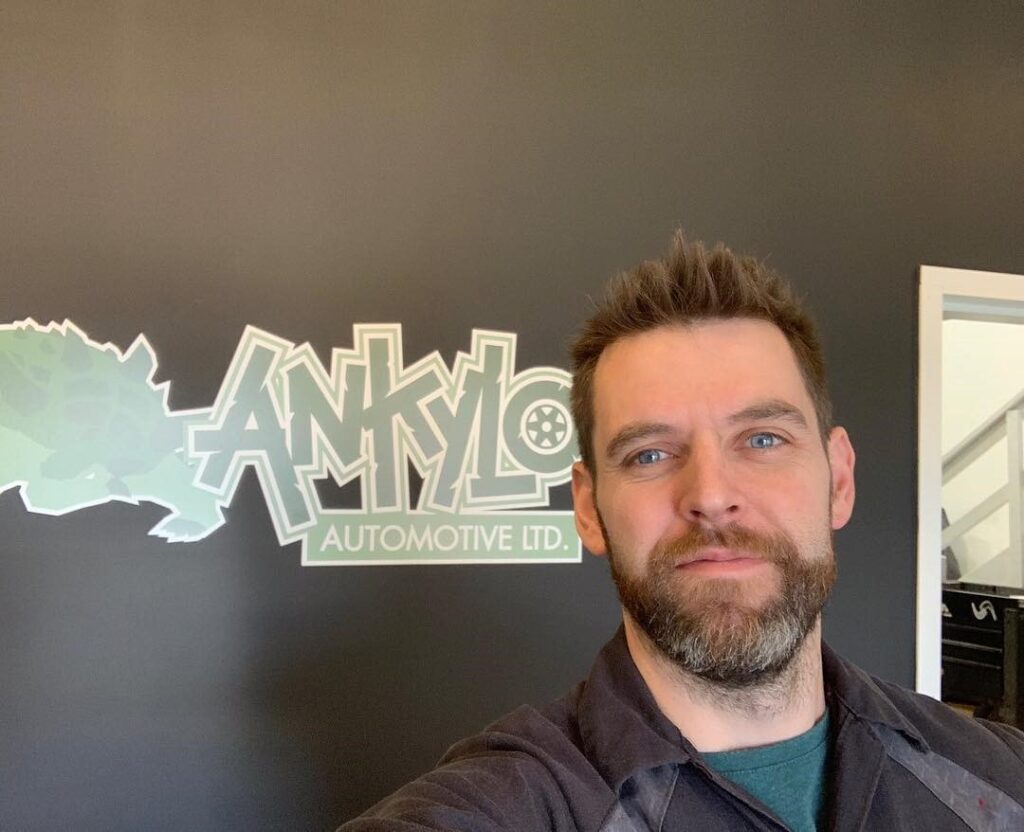 Kyle in the shop, in front of the Ankylo wall